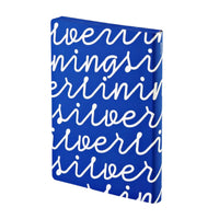 A blue notebook with white text 'SILVER LINING' printed on the cover.